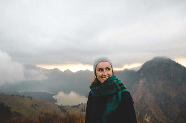 Woman smiling as she hikes in the mountains