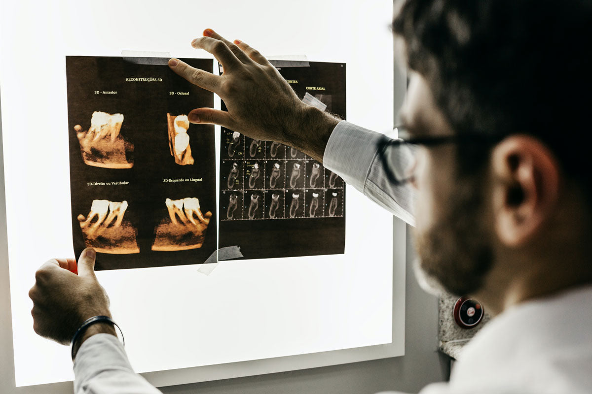 Dentist looking at xrays