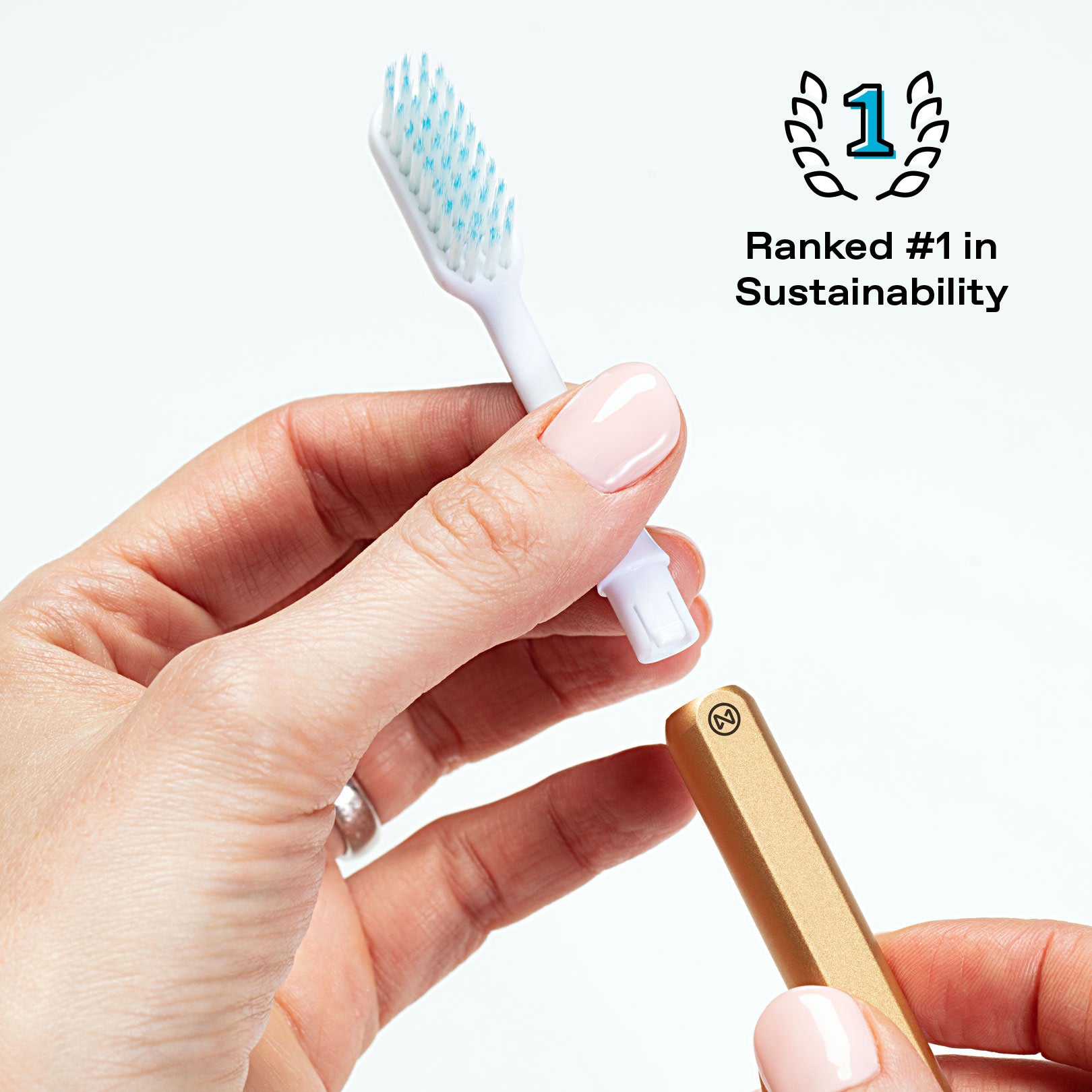 Gold Nada handle with a recyclable plastic brush head being removed and an icon stating "Ranked #1 in Sustainability"