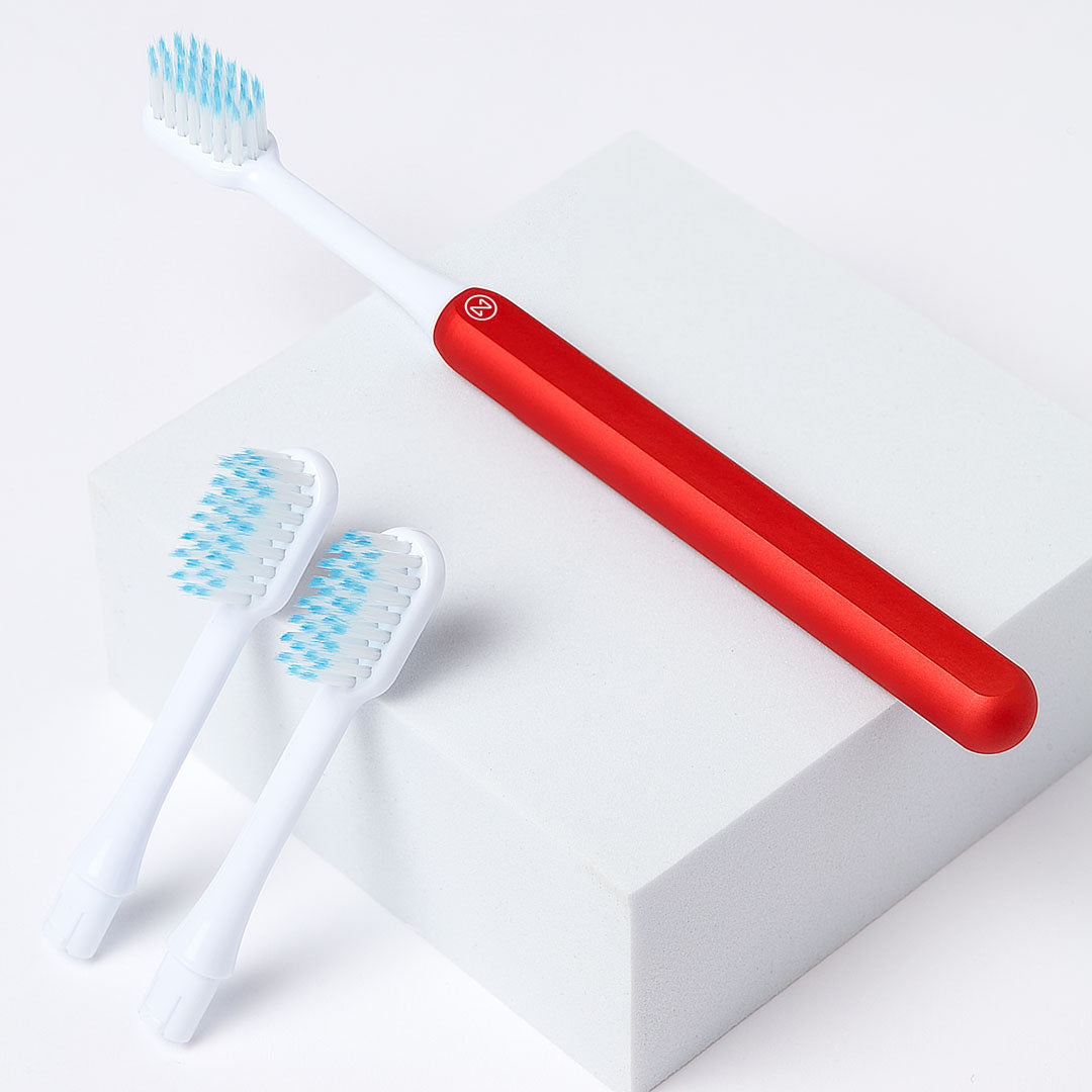 Nada Kids eco-friendly Red toothbrush with a metal handle and recyclable toothbrush heads