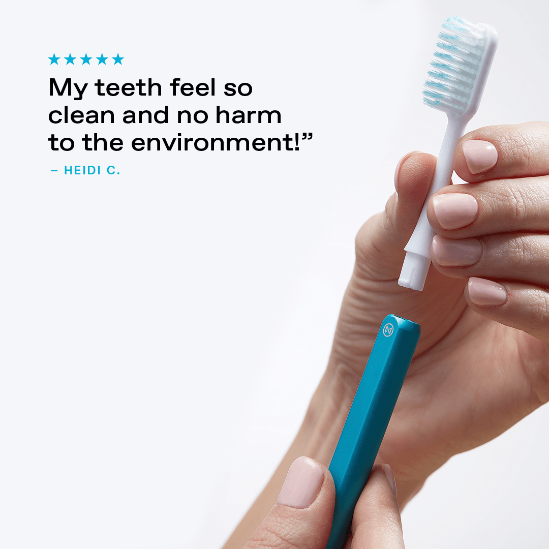 Hand removing the brush head from an Arctic Blue Nada toothbrush with a customer testimonial: "My teeth feel so clean and no harm to the environment!"