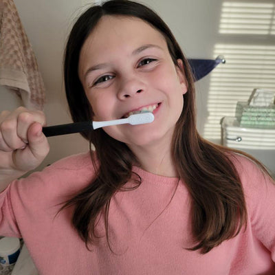 georgia with a black sustainable nada toothbrush