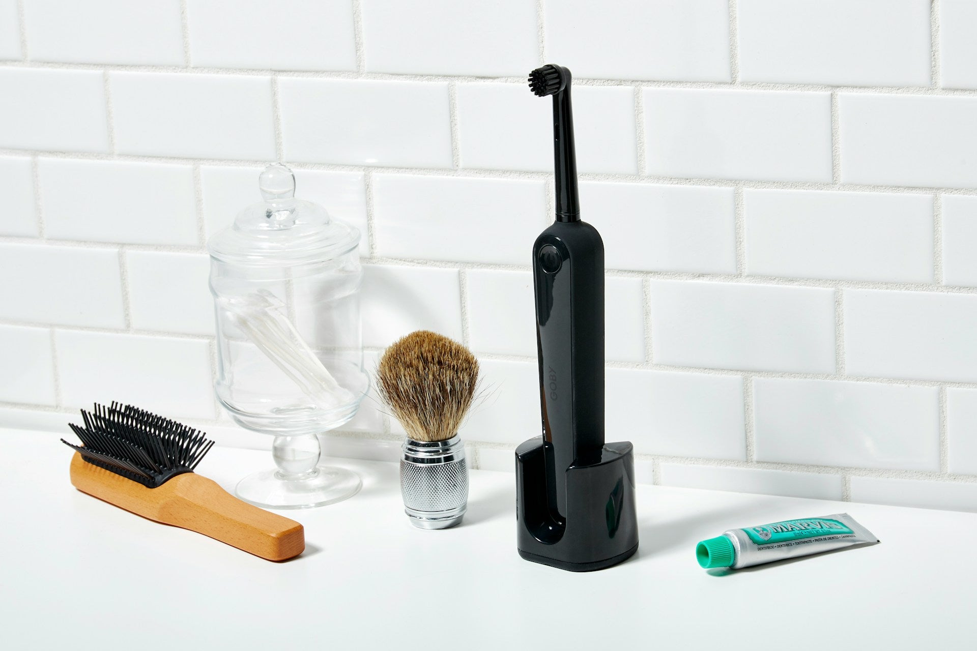 A black electric toothbrush on a countertop