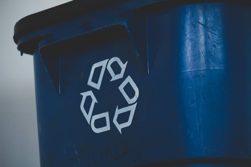 Blue bin with recycling symbol
