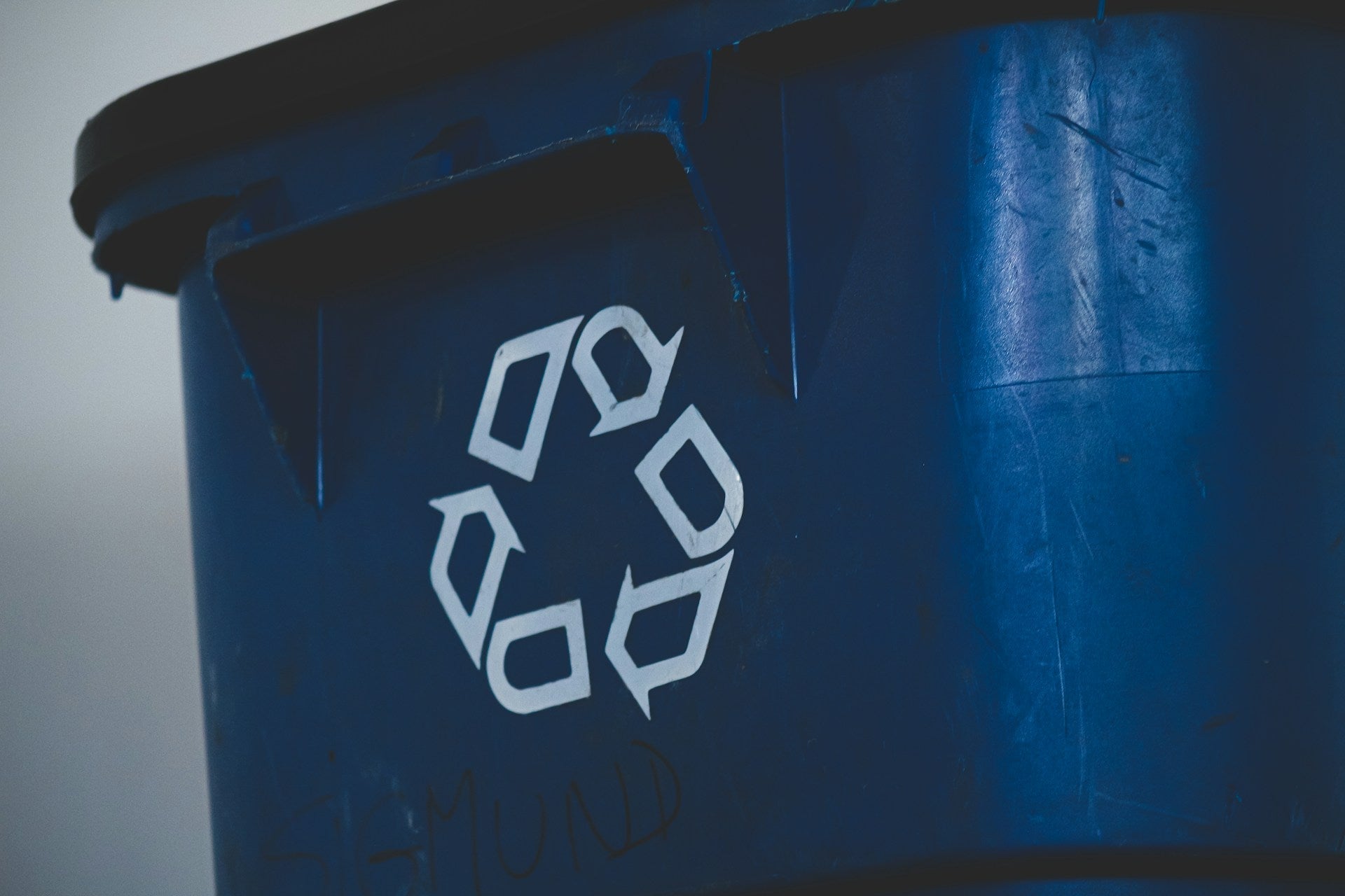 Blue bin with recycling symbol