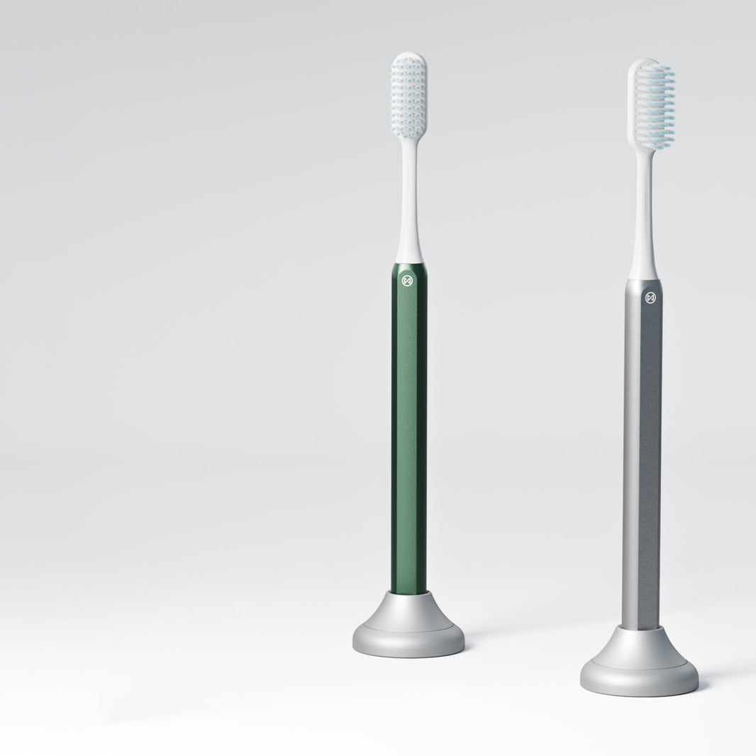 Green and Silver Nada toothbrushes in Nada toothbrush stands