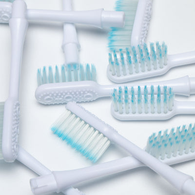 Why do dentists recommend soft toothbrushes?
