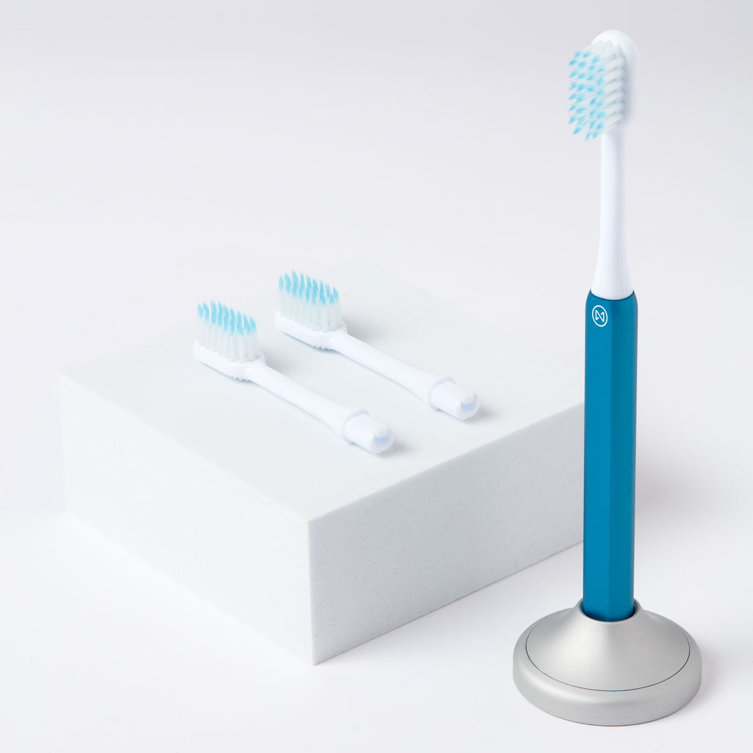 Blue Kids Nada sustainable toothbrush with recyclable toothbrush heads and an aluminum toothbrush stand