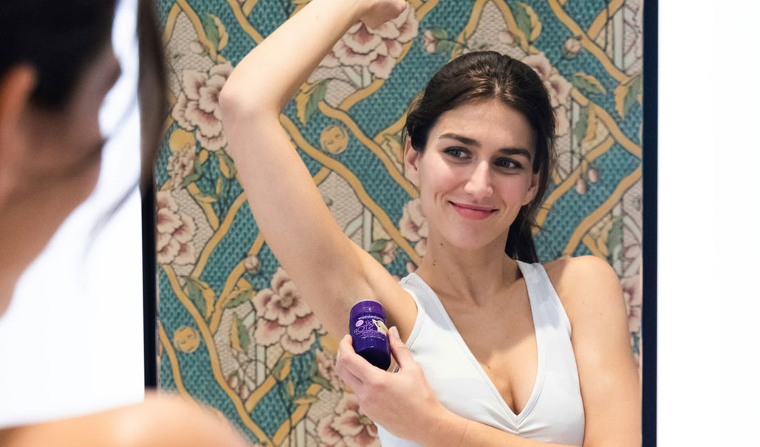 Woman putting on eco friendly deodorant  
