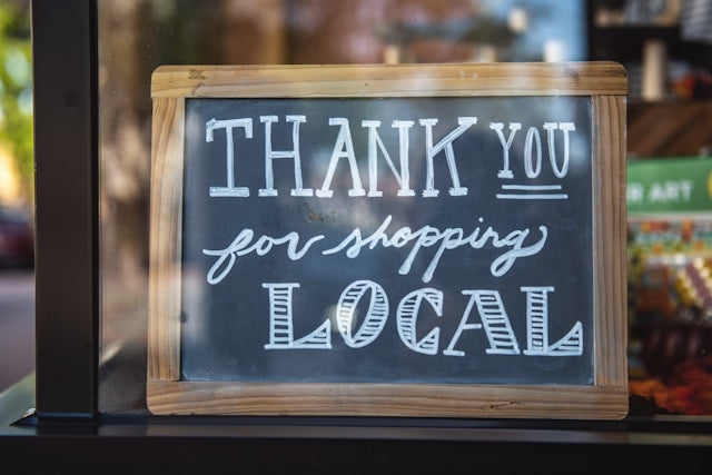 Thank you for shopping local sign in a shop window