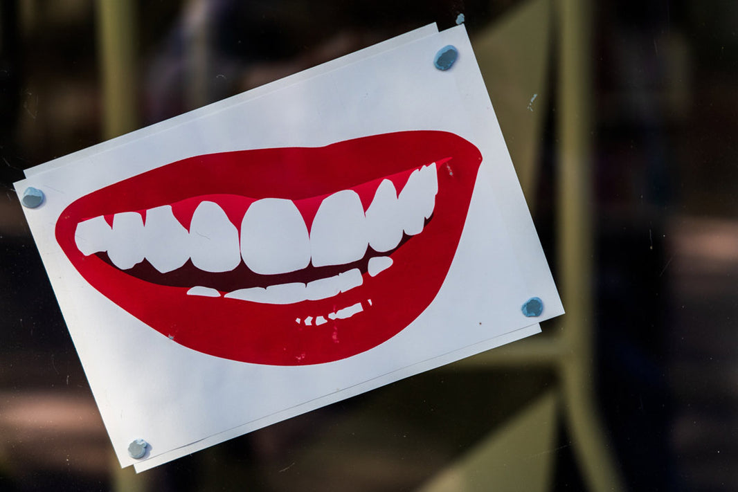 Poster with an image of a smile with red lips and white teeth