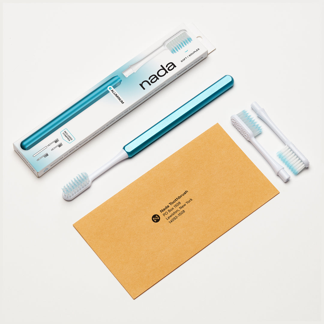 Arctic Blue Nada Toothbrush Starter Kit with a metal handle, 3 replacement toothbrush heads and a self-addressed return envelope for recycling the used brush heads