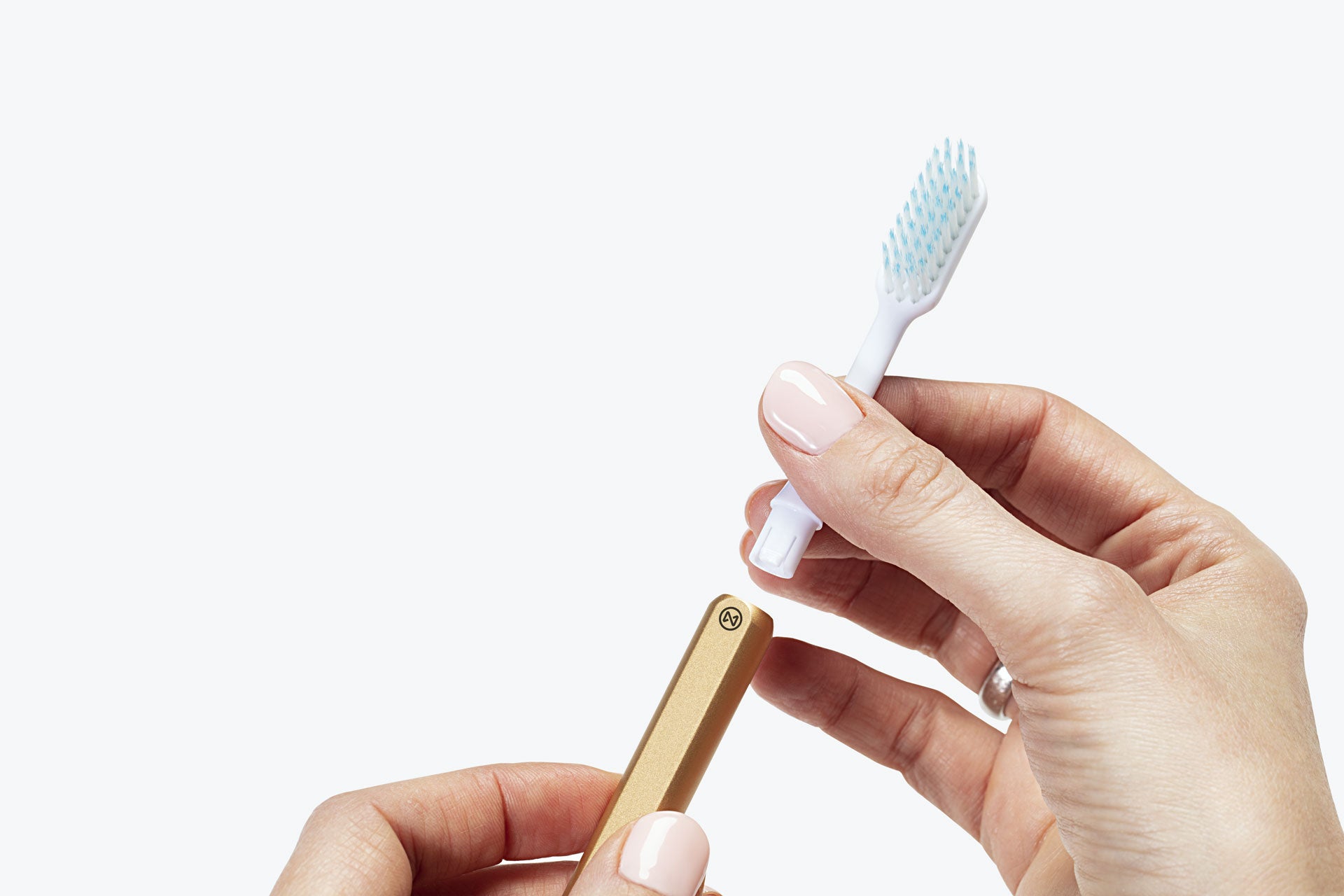 Eco-friendly Gold Nada toothbrush with hand removing the brush head