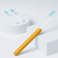 Nada Kids eco-friendly Gold toothbrush with a metal handle and recyclable toothbrush heads