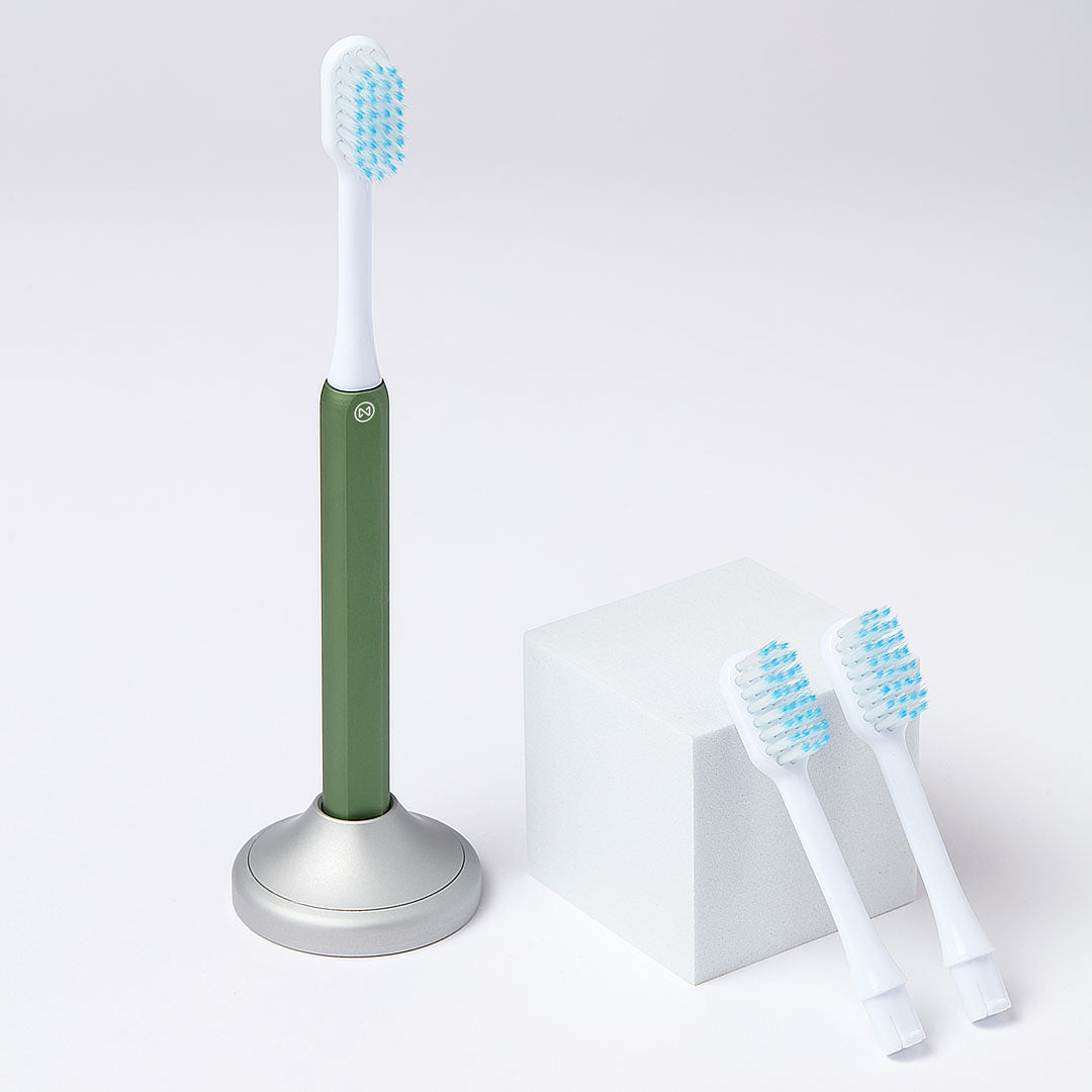 Nada Kids eco-friendly Green toothbrush with a metal handle and recyclable toothbrush heads