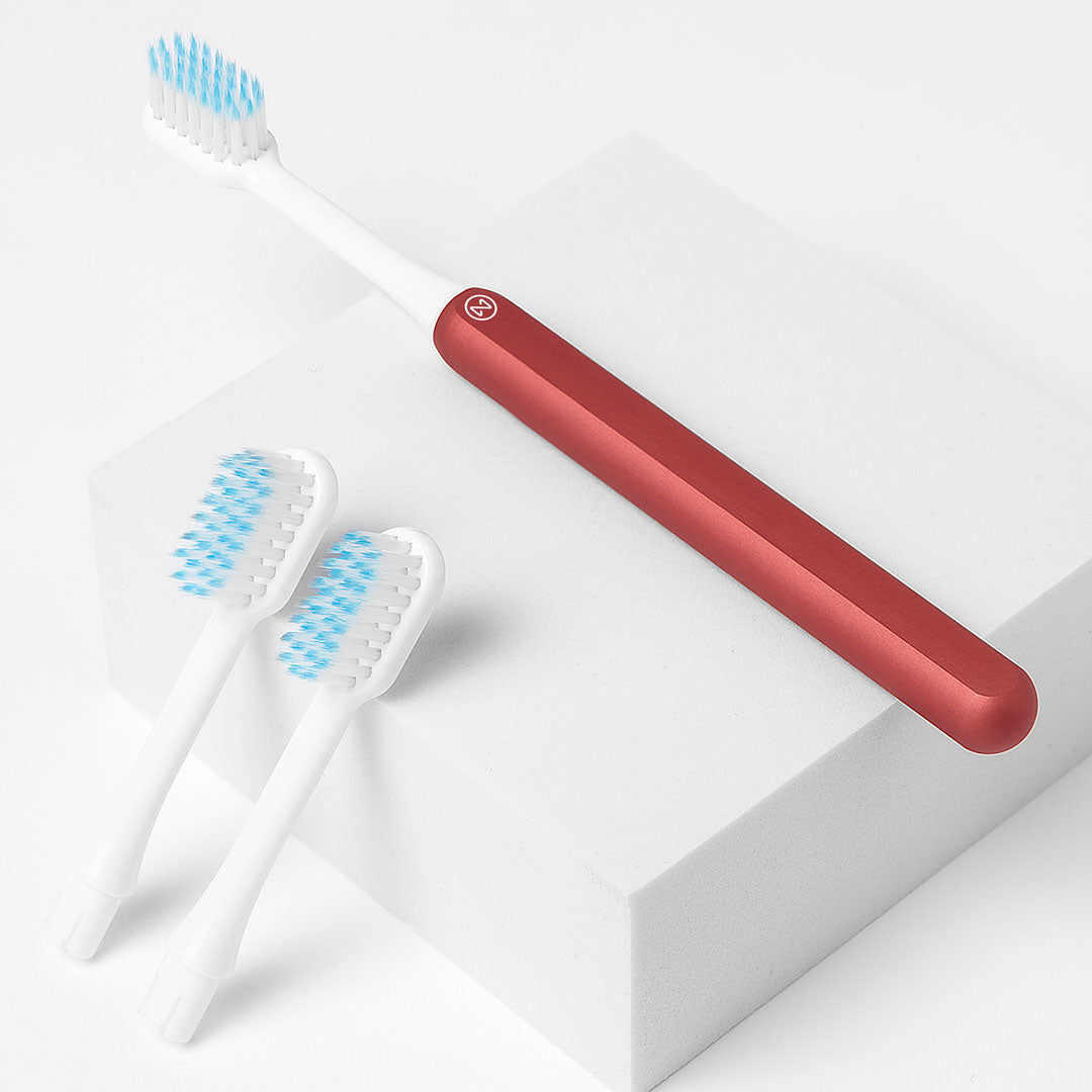 Nada Kids eco-friendly Red toothbrush with a metal handle and recyclable toothbrush heads