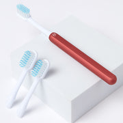 Nada Kids eco-friendly Red toothbrush with a metal handle and recyclable toothbrush heads