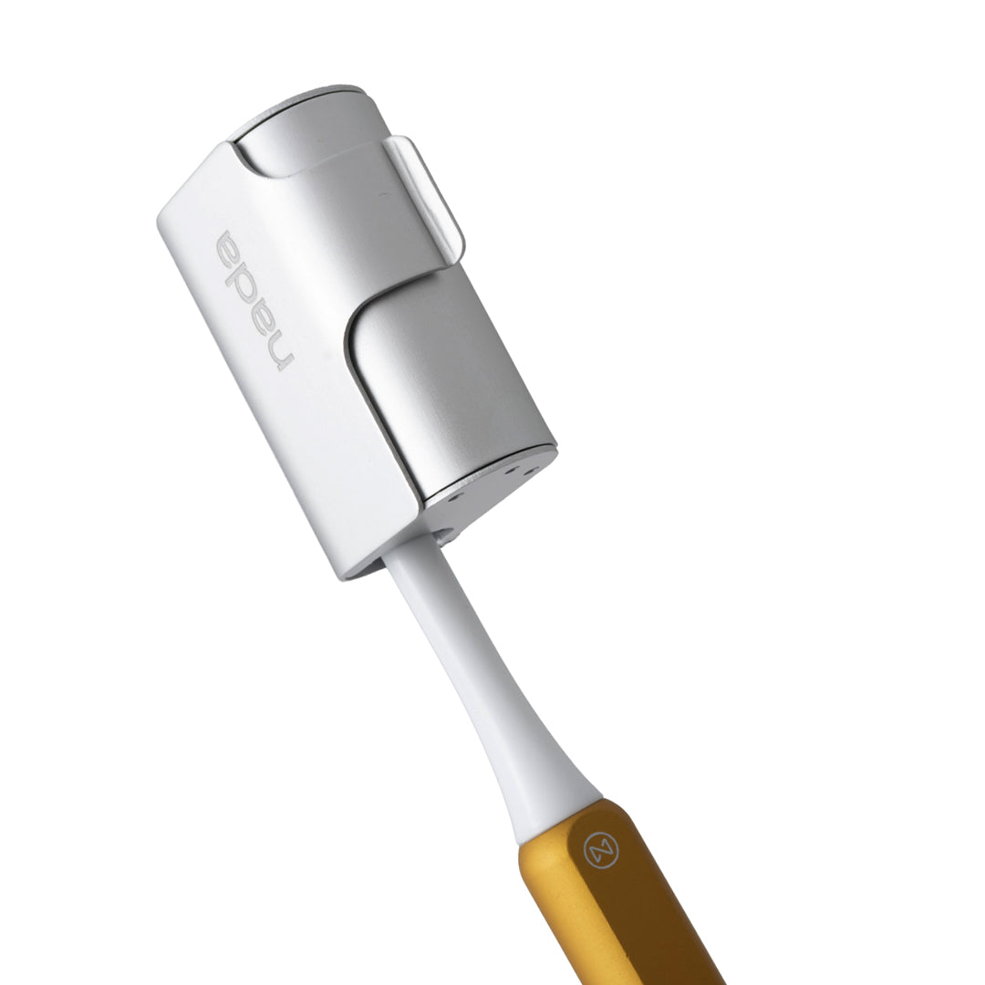 Nada aluminium Silver toothbrush travel cover on a Gold, sustainable, Nada toothbrush 