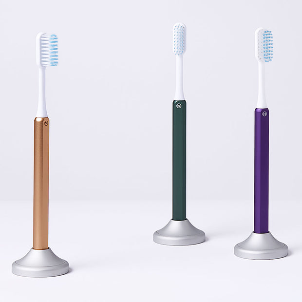 Gold, Green and Purple Nada Toothbrushes in Nada Aluminum Toothbrush Stands