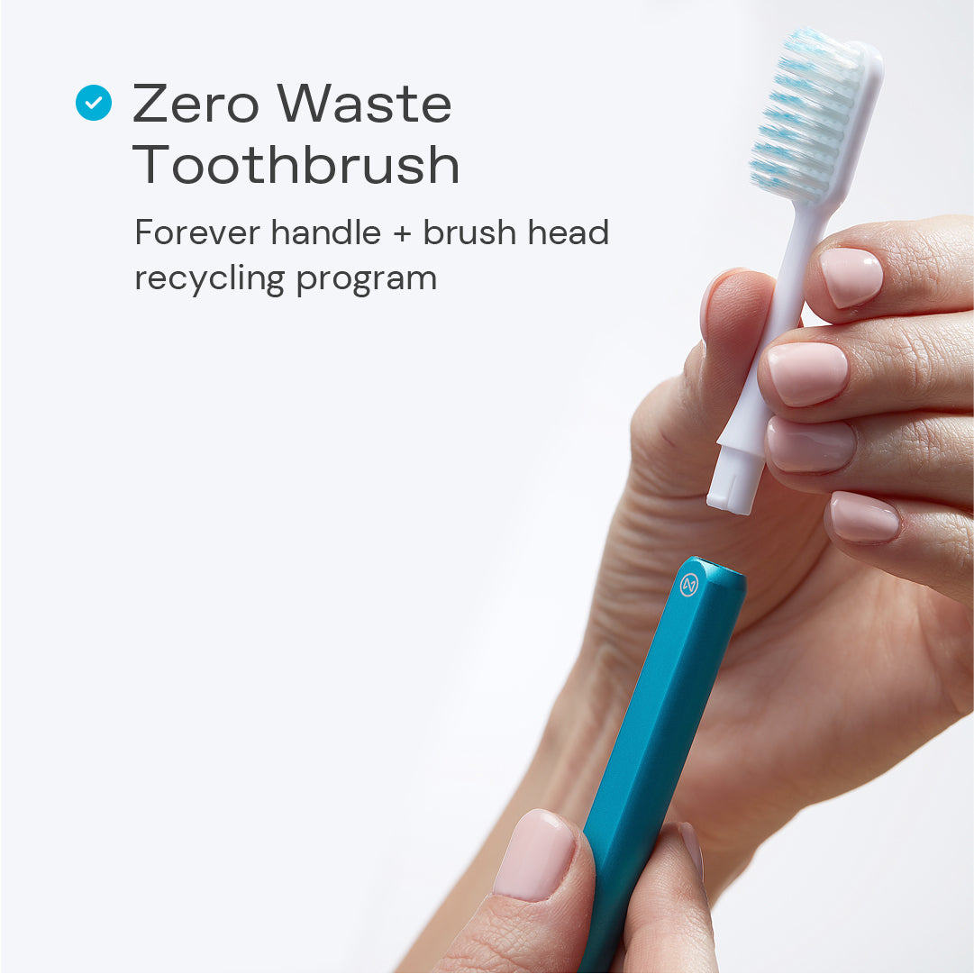 Zero waste Nada Toothbrush with a hand removing the recyclable brush head from the aluminum handle