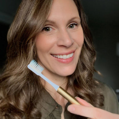 christine with a gold eco friendly nada toothbrush