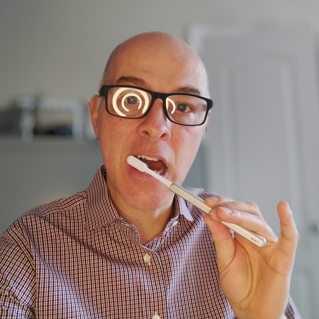 David using a silver Nada sustainable toothbrush