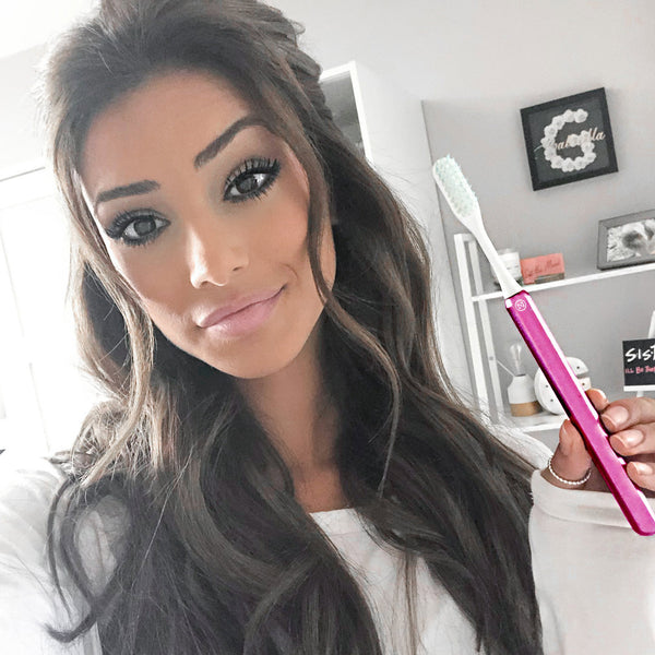 Gabriella smiling with pink Nada toothbrush