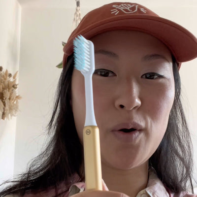 kaya with a sustainable gold nada toothbrush 