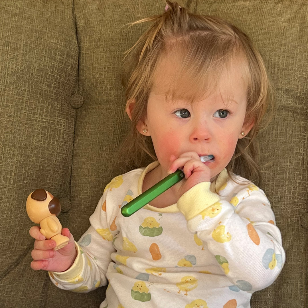 child-using-lime-green-nada-sustainable-toothbrush
