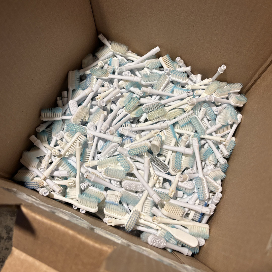 Used Nada toothbrush heads in a box being sent to be recycled
