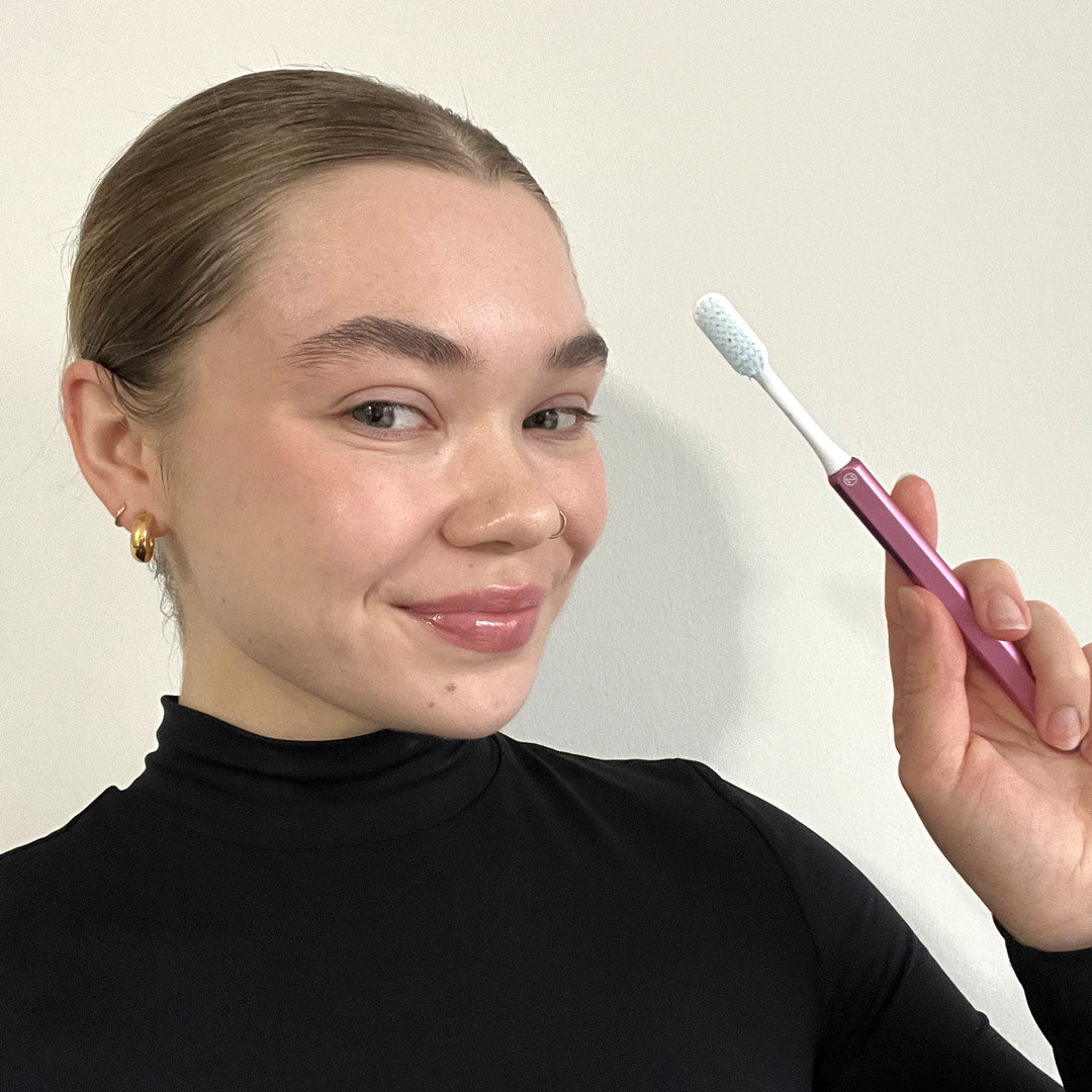 Kaylee with a pink Nada Toothbrush