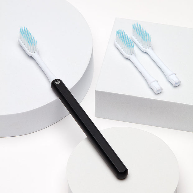 Black Nada Sustainable Toothbrush with a Metal Handle and Replacement Toothbrush Heads