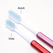 Size comparison between a Nada Kids toothbrush head and an adult toothbrush head